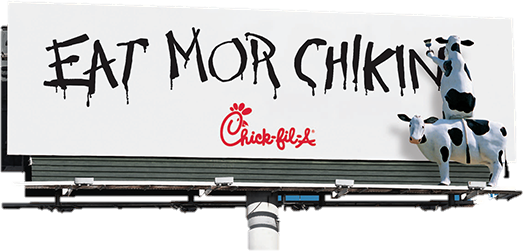 A Chick-fil-A billboard reading &ldquo;Eat Mor Chikin,&rdquo; hand-lettered in dripping black paint, with cows perched on top of the sign.